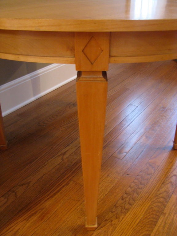 Very Elegant Round Sycamore Dining or Center Table.   Beautiful tapered legs with carved caps.