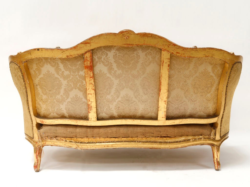 This settee was purchased from a country estate in the region of Montpellier, France.  The piece is gently worn and the gold leaf has a lovely patina.