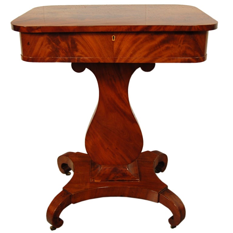 Magnificent crotch mahogany period Karl Johan (Biedermeier) lyre-shaped pedestal base table. Originally handcrafted as a sewing table, today it makes a wonderful end or side table.