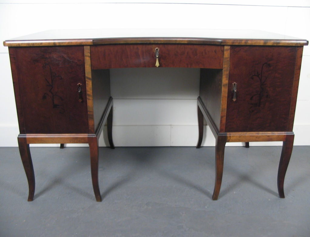 Swedish Art Deco Neoclassical inlaid writing table or desk:<br />
<br />
- Crafted of native Swedish flame birch - both dark and golden in color.<br />
- Intarsia (inlay) of various hardwoods.<br />
- Brass finish pulls are original.  <br />
- Key
