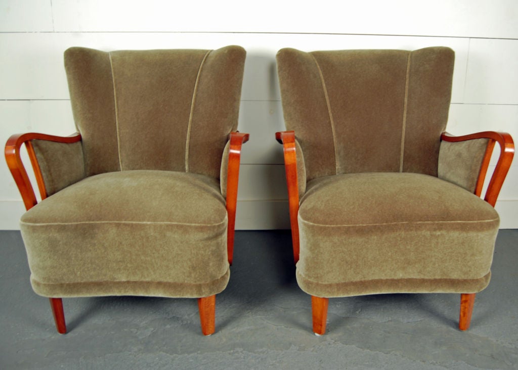 Pair of armchairs newly restored and reupholstered in moss green mohair velvet with exposed sleek mahogany arms and legs.  <br />
<br />
Fabric swatch available upon request.<br />
<br />
Please contact us with any questions!