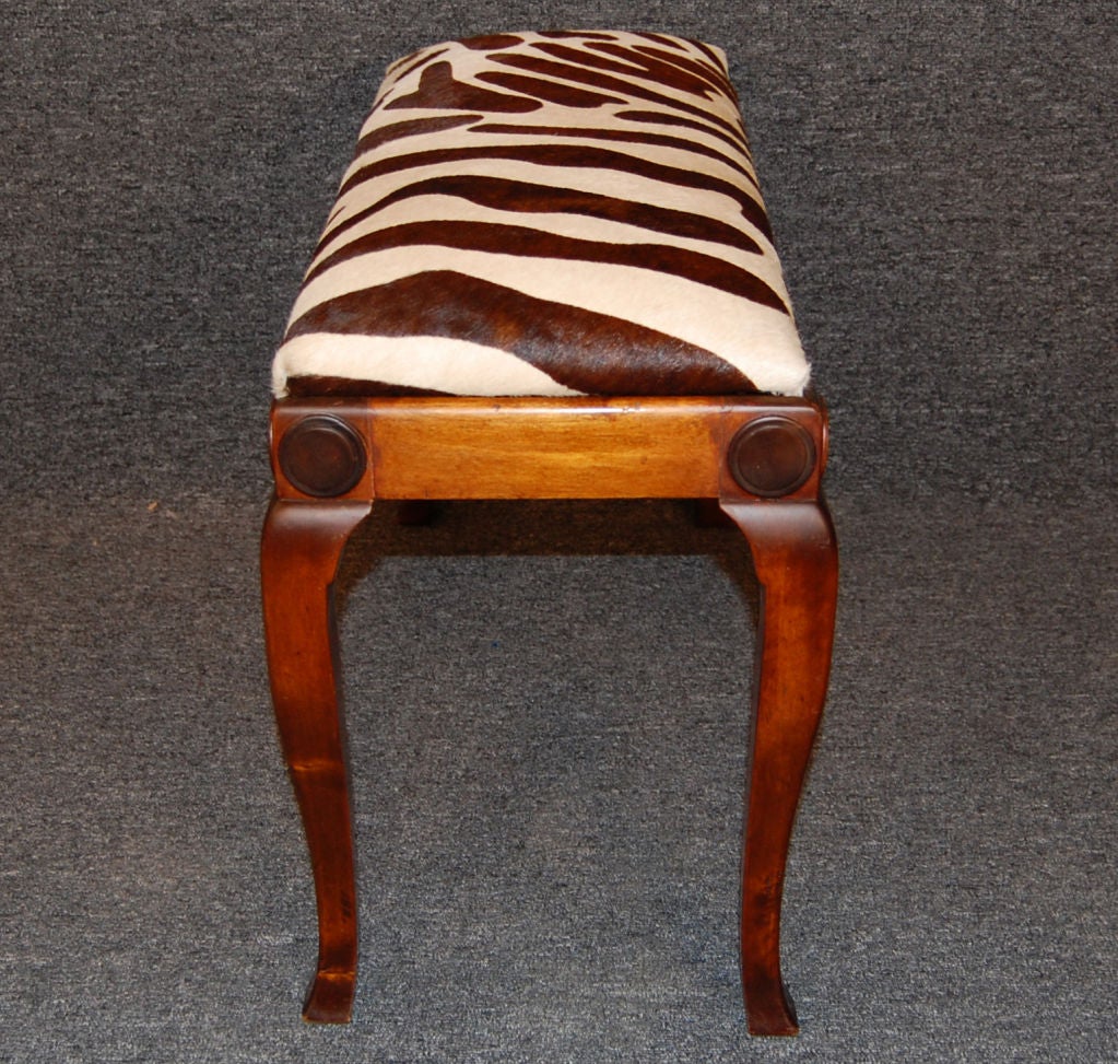 Delightful piano bench newly restored and reupholstered in Dark brown and black zebra print hair-on-hide.<br />
<br />
Leather swatch available upon request.<br />
<br />
Please contact us with any questions!