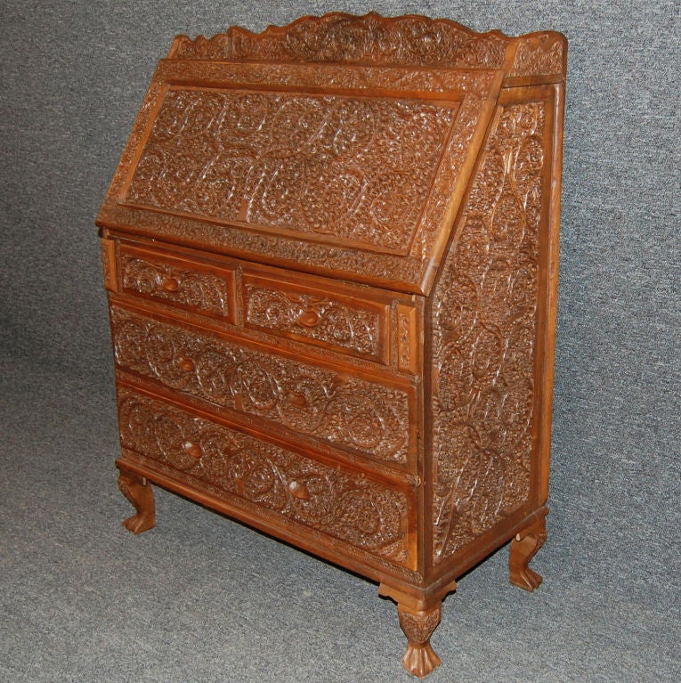 Unique Burmese teak secretary with intricate hand-carved leaf and floral motifs.  Very sturdy and robust, this piece makes a great home office within itself.  In excellent condition for its age.<br />
<br />
Key included.<br />
<br />
This was a