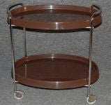 Modern bar/serving cart of dark brown molded plastic on a chrome frame with wheels.<br />
<br />
Pattern seen in photos in top tray is a reflection - all of the trays are very smooth, glossy and solid brown!