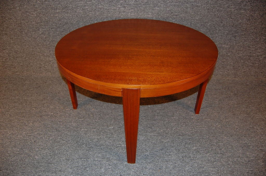 Round teak coffee table or end table with tapered inset legs.