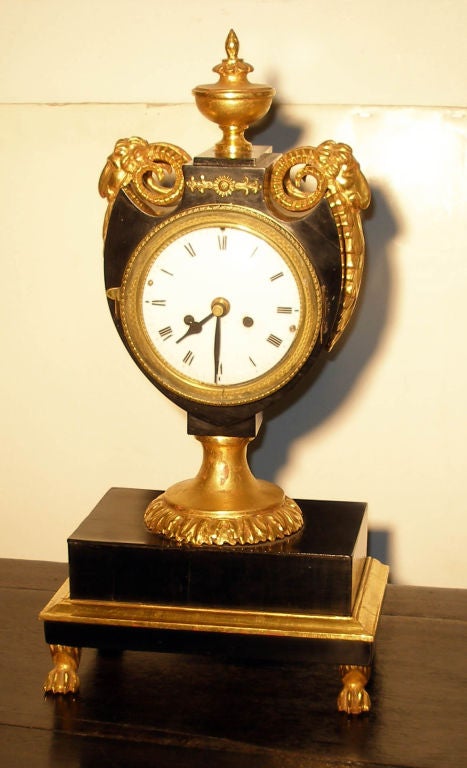 French empire lacquer and gilt lyre form mantle clock with goat surmounts