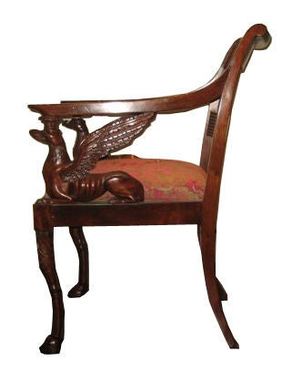 Russian arm chair with winged griffin on arms.  Mahogany wood.  Having paw feet.