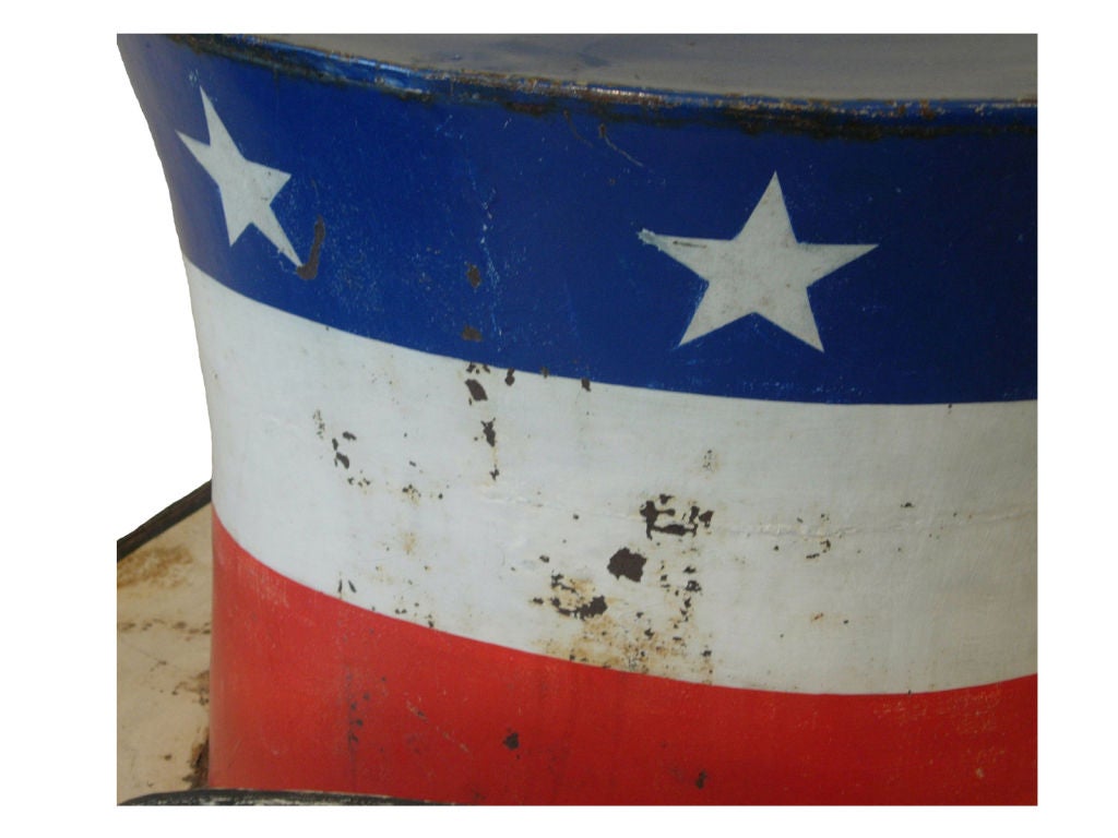 Early 1900 oversized tinsmith trade sign in the form of a 19th century top hat, painted in a bold red, white and blue first surface patriotic scheme with a band of white stars around the upper portion of the hat with a black painted band around the