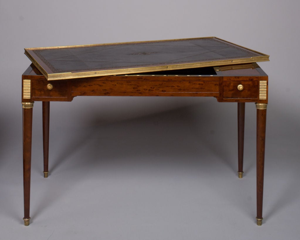 An important French Louis XVI period, tric trac table of mahogany and mahogany veneer stamped, “BENEMAN”, by its maker, Guillaume Beneman.  Each angle of the table frieze has small rows of gilt bronze.  The edge of the removable top is banded with