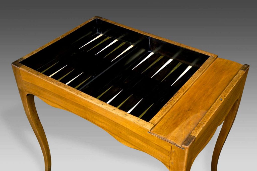 A fine French, walnut game table (Table à Jeu) of the Louis XV/Louis XVI transitional period stamped, “Hache Fils à Grenoble” by its maker, Jean-François Hache (1730-1796). The removable, checkerboard marquetry top is made for a game of chess, and