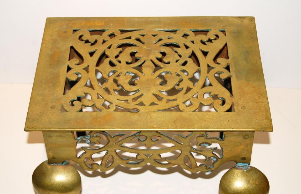 Brass footman trivet with fine cutouts, including hearts; 18th century England
