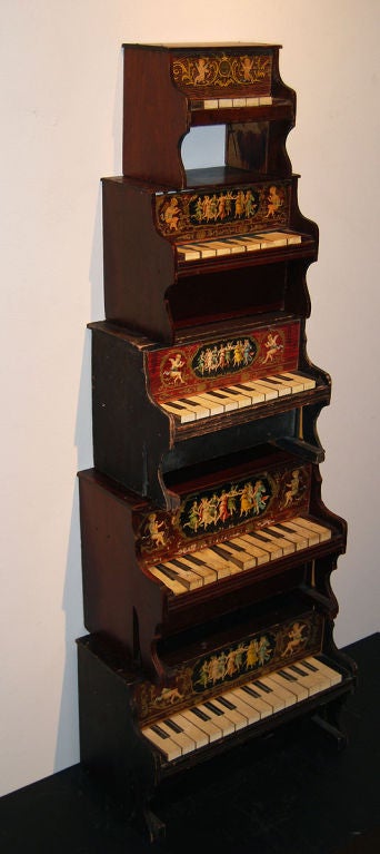 A collection of five toy pianos from the A. Schoenhut Company in Philadelphia, circa 1910; with whimsical images of dancing women. Sold as a group.