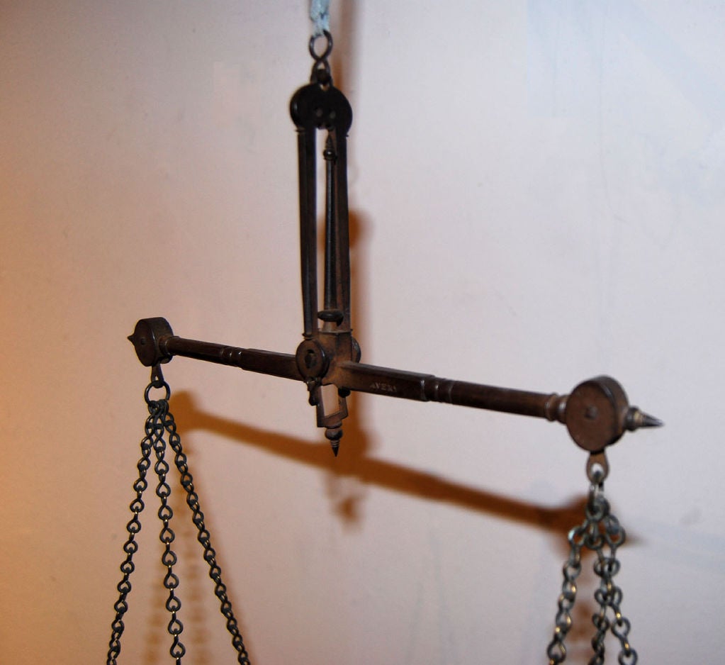 Early 19th century hanging scale from England stamped Avery in the cross bar, with brass dishes marked, as well (see images).