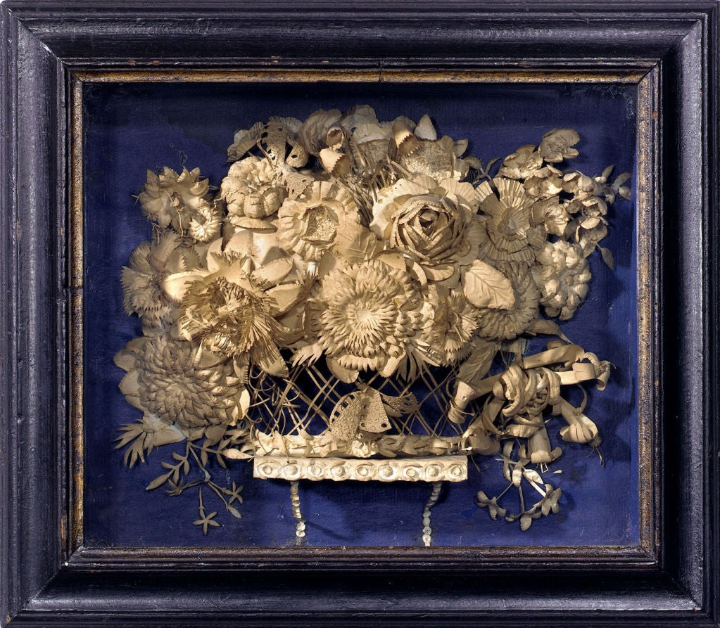 Outstanding pair of shadowbox pictures exhibiting baskets of flowers worked entirely in cut and curled paper. The interior of the shadowboxes are lined in a deep blue paper. English, circa 1780. The shadowbox frames are original, and they are sold