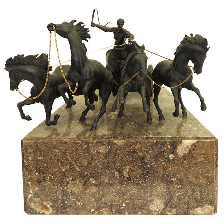 Mounted on brown marble triangular base, male figure guiding four charging horses. Beautifully detailed two-wheel chariot.
