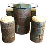 Torch-cut Metal Drum Table and Four Stools by Chuck Phillips