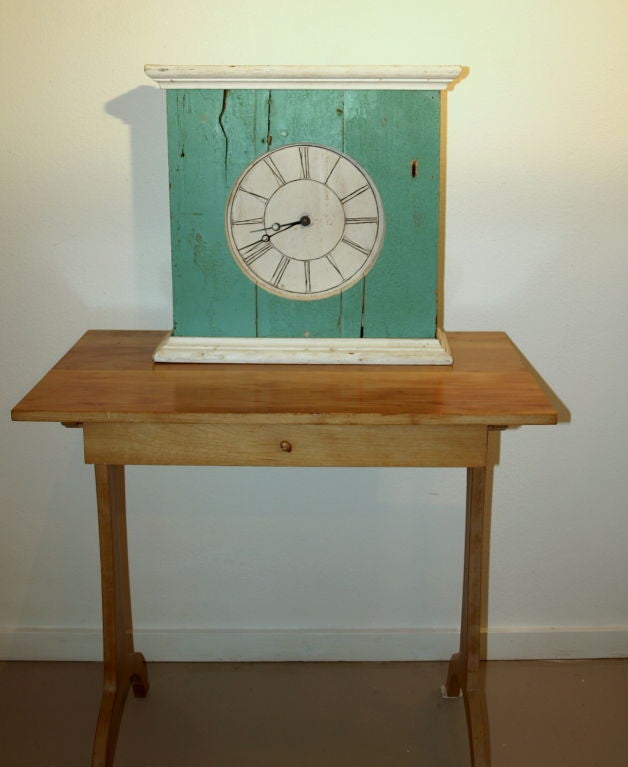 Well known and listed artist/sculptor from Provincetown, MA, Jim Manning, used old pieces of wood and clock parts to create a folk art or country looking turquoise wood assembled clock for which he is noted for.  The clock runs off of a single AA