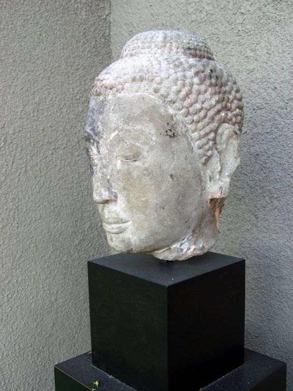 With delicate features and with very serene expression. Cambodian dating from the Khmer Period, between the 12th - 14th century on a modern base.

Provenance and certificate of authenticity verifying period and origin is available upon request and