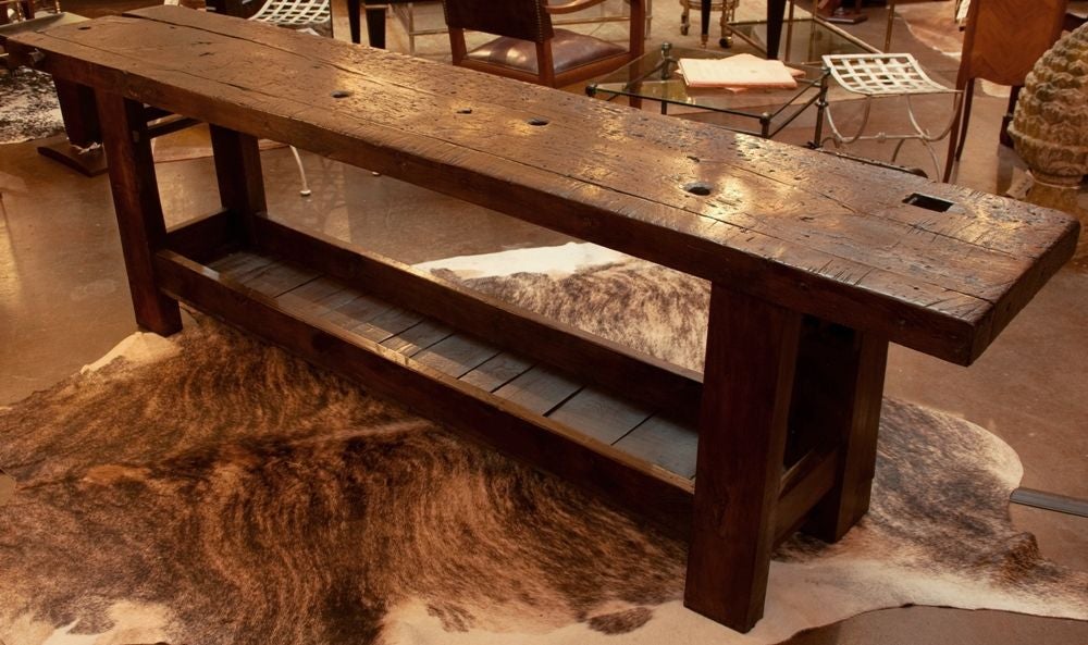 Spectacular antique French carpenter's work table in solid walnut with original functioning clamp, beautifully distressed wood with a stunning patina.