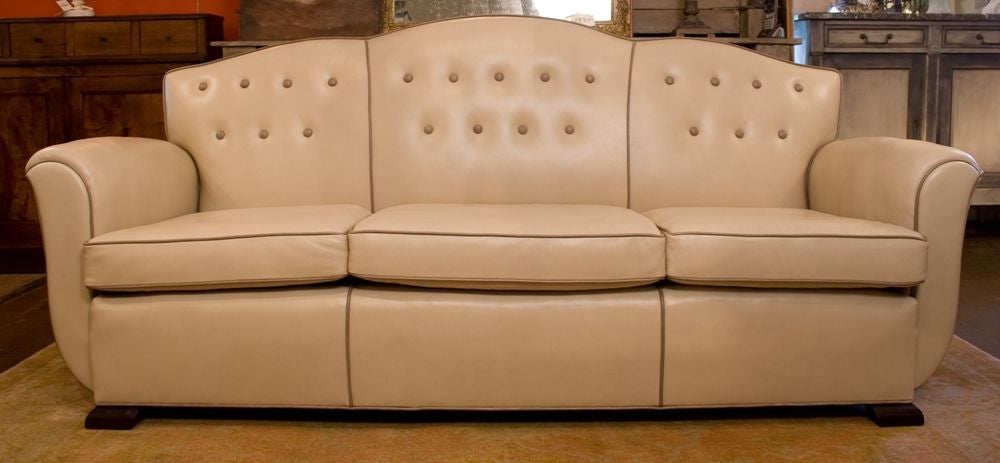 Stunning French Art Deco period sofa by Dominique, original solid mahogany legs, reupholstered in high-grade Argentine leather.
