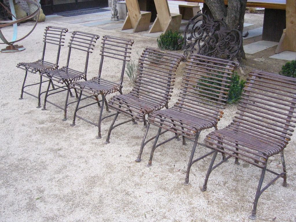 Three Arras garden chairs from France dating back to the 1890's. The chairs have a metal slatted back rest and slatted seat. Priced individually for $1,200 each.