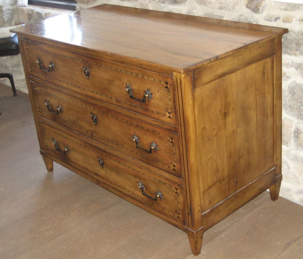Walnut Directoire-Style Commode with three pull-out drawers. Starburst hardware with hardwood inlay design. Each drawer with metal plaque keyhole.

