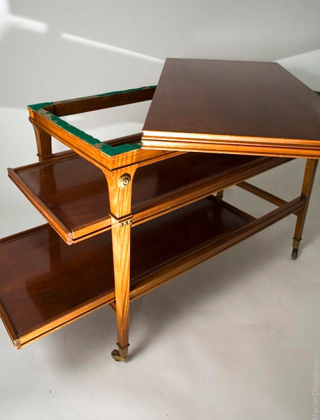 Bronze mounted mahogany French serving table with extendable shelves and lift top.