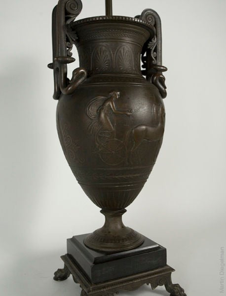 Pair of nicely patinated bronze lamps of urn form in the neoclassical style.
Shade not included.