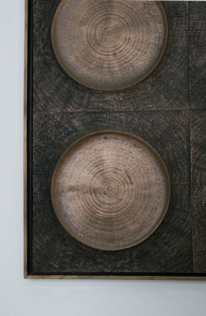 Forms +Surfaces bronze architectural panel, designed by Paul Tuttle, c. 1970's. Great textured bronze resin around bronze circles, bonded onto wood backing, frame is miltered wood with dark stain and painted front. This can be hung vertically or