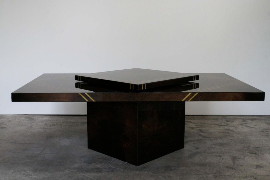 Beautiful Maison Lancel coffee table, made in France, circa 1970s. Features a swivel top that reveals a hidden cubby hole originally for ice and drinks, can be used for magazines, etc. The finish is an original shimmery brown, black, and gold with a