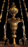 This delicately carved Biedermeier chandelier is made of gilt limewood. Four chains eloquently blend into the eight delicate arms of this chandelier. These arms originally held candles, but have since been electrified.
