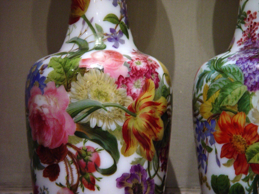 Painted By <br />
CIRCA 1840-50<br />
<br />
The vases, painted by Jean-François Robert, are of baluster form with a flared neck and they rest on a circular foot. The vases are delicately decorated with polychrome Spring flowers including; wild