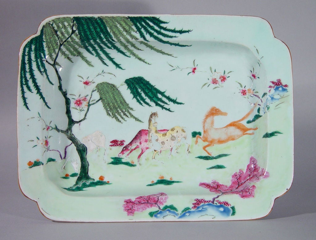 The rectangular tureen with canted corners is finely decorated with a scene decorated in famille rose of three colourful horses in a meadow beside a large Chinese willow tree which rises on the left and whose branches and leaves shade the three