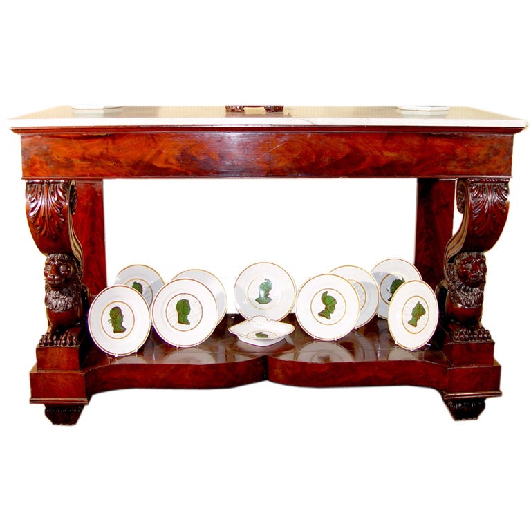 The Lucca Tuscany mahogany console with the original white marble rectangular top is raised on the front corners on a large acanthus leaf scroll supported on the backs of recumbent lions, their heads raised. 

The back had rectangular flat