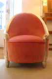 An Art Deco Armchair of carved silvered wood upholstered in pink velvet