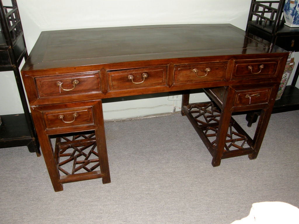 Fine Chinese elmwood desk in three sections. Top with four drawers, and two pedestals each with one drawer and 