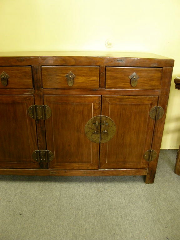 Large Chinese Ca 1840-50 elmwood sideboard altar coffer cabinet, with drawers and amble storage. The cabinet retains its original surface and hardware. Found in Ning-bo province China. Photos shown with and with out a flash.