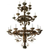 A painted tole and iron chandelier, 28 lights in 3 tiers