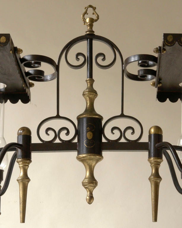 An unusual Charles X style tole, brass, and iron chandelier In Good Condition In New York, NY