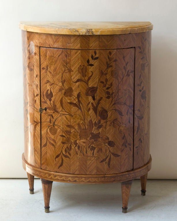 A Louis XVI style demilune side cabinet floral marquetry decoration with a yellow marble top, continental, 19th century.

Width 25