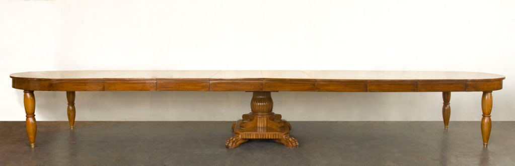 A French Restauration style walnut dining table with 8 leaves