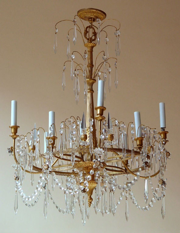 A neoclassical (Liberty style) gilt metal eight-arm chandelier with glass and crystal drops, Continental, circa 1920, wired for electricity.
Diameter 25