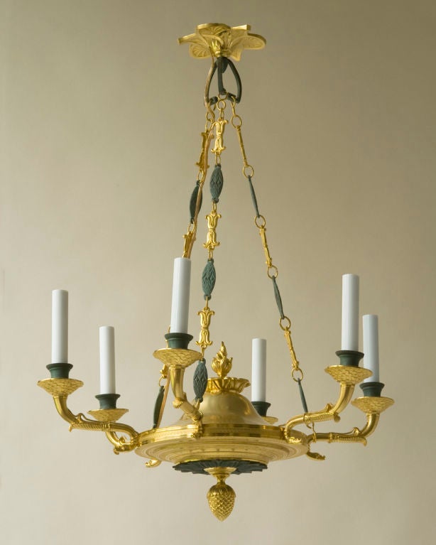 An Empire style chandelier, gilt and green patinated bronze, six lights, with original chain and canopy, Continental early 20th century, wired for electricity.

Diameter 20 1/2