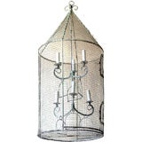 A white painted metal birdcage wired as a lentern