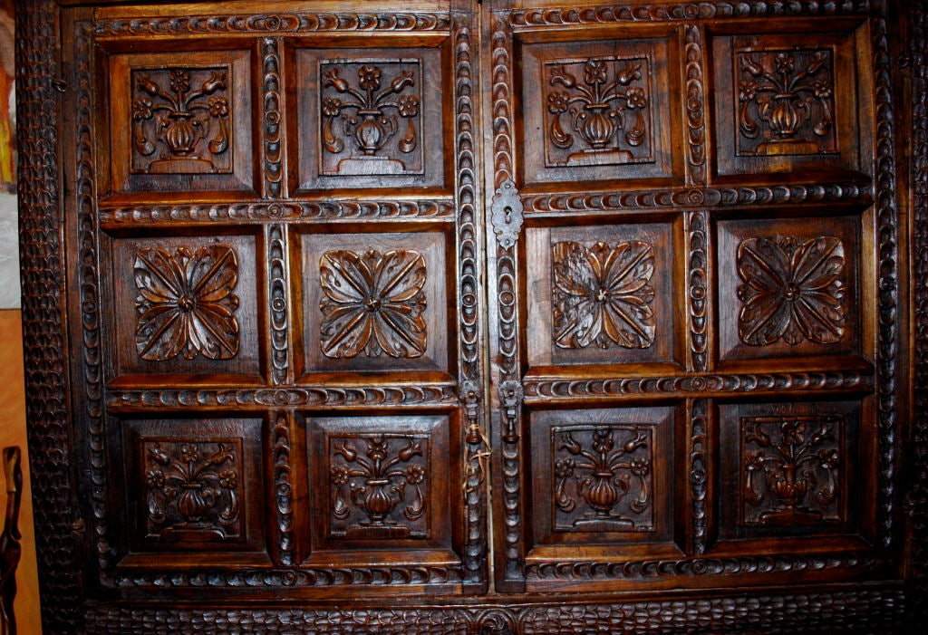 Very fine Spanish Colonial armoire circa mid 1700's.  Heavily carved throughout. Featuring floral patterns and designs.  Original wrought iron hardware.