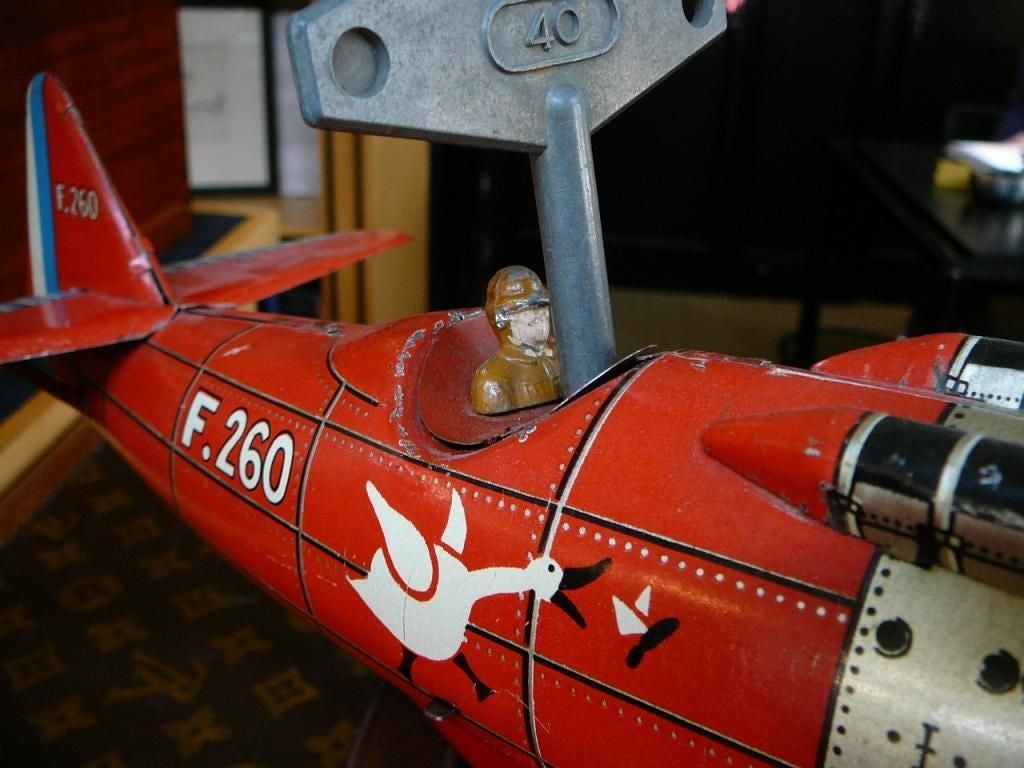 A very rare lithographed, clockwork-powered Art Deco tinplate toy hydroplane, a rare surviving example of quality and interest in superb and unrestored condition complete with original key and ‘pilot’. A model based on the French Dewoitine racing