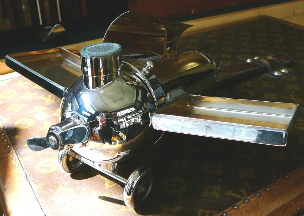 A very rare Art Deco 'smoker’s companion', in the form of a stylised aeroplane, manufactured in Germany by J.A. Henckels in the late 1920s. Facilities afforded the smoker include a cigar box in the fuselage, a pair of removable cigarette cases in