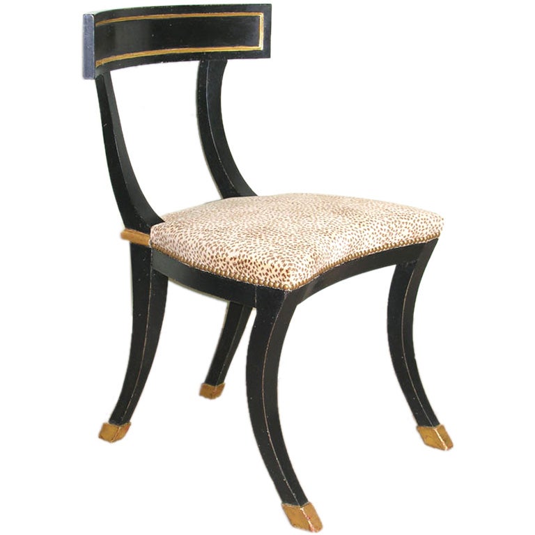 black and gilt klismos dining chairs
