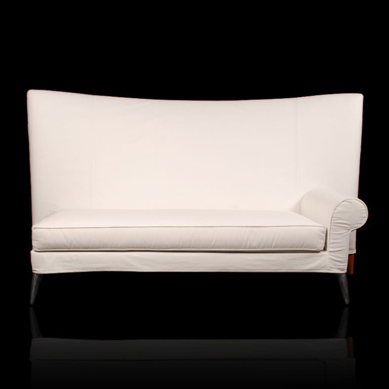 This whimsical sofa with its sweeping and dramatic high back was designed by the French Designer Philippe Starck. Called the Royalton Sofa, this is one of the many pieces originally designed for the Royalton Hotel in New York in 1991. Produced by