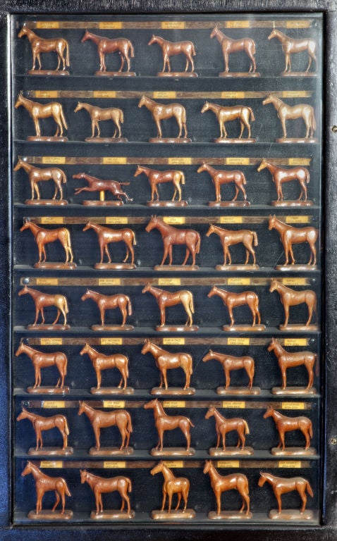 Kentucky Derby Winner Shadow Box<br />
Midwest<br />
Each horse hand carved with label below noting name and date of winner. Winning horses range from 1875-1954. Enclosed in black shadow box with glass and hinged center.
